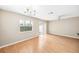 Bright, spacious living room featuring hardwood floors, a ceiling fan, and large window views at 5004 Ashford Falls Ln, Oviedo, FL 32765