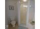 Bathroom featuring a toilet and stand-up glass shower at 5300 S Atlantic Ave # 4-302, New Smyrna Beach, FL 32169
