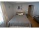 Cozy bedroom with a full bed and decorative pillows, a nautical theme, and ensuite bathroom at 5300 S Atlantic Ave # 4-302, New Smyrna Beach, FL 32169
