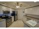 Bright kitchen with stainless steel appliances, tile floors and countertops at 5300 S Atlantic Ave # 4-302, New Smyrna Beach, FL 32169