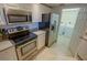 The well-lit kitchen has stainless steel appliances, granite counters, and an adjacent laundry room at 5300 S Atlantic Ave # 4-302, New Smyrna Beach, FL 32169