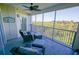 The lanai features comfortable seating and a ceiling fan with calming views of the surrounding nature at 5300 S Atlantic Ave # 4-302, New Smyrna Beach, FL 32169