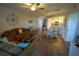 Bright and airy living room with dining area and kitchen access; features hardwood floors at 5300 S Atlantic Ave # 4-302, New Smyrna Beach, FL 32169