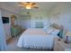 Serene bedroom with dresser, TV, and soothing pastel decor at 5300 S Atlantic Ave # 4-302, New Smyrna Beach, FL 32169