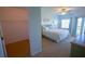 Bright main bedroom with walk-in closet and a sliding glass door to the balcony at 5300 S Atlantic Ave # 4-302, New Smyrna Beach, FL 32169