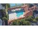 Aerial view of the kidney-shaped pool surrounded by lounge chairs and shaded seating areas at 5300 S Atlantic Ave # 4-302, New Smyrna Beach, FL 32169