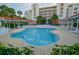 Beautiful kidney-shaped pool surrounded by ample seating for residents and guests at 5300 S Atlantic Ave # 4-302, New Smyrna Beach, FL 32169
