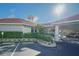 Exterior of the recreation building with lush landscaping and designated parking spots at 5300 S Atlantic Ave # 4-302, New Smyrna Beach, FL 32169