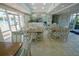 Recreation room with tiled floors, plenty of seating, and access to the community pool at 5300 S Atlantic Ave # 4-302, New Smyrna Beach, FL 32169