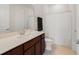 Bathroom featuring a large mirror, vanity with dark wood cabinets, and shower at 5660 Oak Knoll Dr, St Cloud, FL 34771