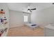 Bright bedroom featuring a ceiling fan, window and carpeted floors at 5660 Oak Knoll Dr, St Cloud, FL 34771