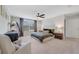Spacious main bedroom with neutral decor, ceiling fan, large bed, and carpeted floors at 5660 Oak Knoll Dr, St Cloud, FL 34771