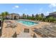 Community swimming pool surrounded by lounge chairs, tables, and well-manicured landscaping for relaxation at 5660 Oak Knoll Dr, St Cloud, FL 34771