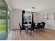 Dining area with sliding glass doors to the backyard, modern chandelier, and seating for eight at 5660 Oak Knoll Dr, St Cloud, FL 34771
