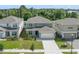 Charming two-story home with a well-manicured front yard, a driveway, and an attached two-car garage at 5660 Oak Knoll Dr, St Cloud, FL 34771