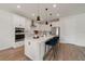 Modern kitchen with stainless steel appliances, white cabinets, and an island with bar seating at 5660 Oak Knoll Dr, St Cloud, FL 34771
