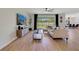 The stylish living room features a large TV, modern decor, and a sliding glass door at 5660 Oak Knoll Dr, St Cloud, FL 34771