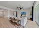 The bright living room features stylish wood floors, an open floorplan, and lots of natural light at 5660 Oak Knoll Dr, St Cloud, FL 34771