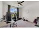 Office space with a desk, treadmill, rowing machine, and large window with view at 5660 Oak Knoll Dr, St Cloud, FL 34771
