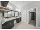 Bathroom vanity with double sinks, a large mirror, and access to a walk-in closet at 5829 Valentino Way, Lakeland, FL 33812
