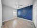 Bedroom features a statement wall, modern ceiling fan, and plenty of natural light at 5829 Valentino Way, Lakeland, FL 33812