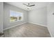 Bright bedroom with laminate flooring, a large window providing natural light, and neutral paint at 5829 Valentino Way, Lakeland, FL 33812