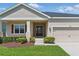Charming home featuring manicured landscaping, an inviting entrance, and well-maintained exterior at 5829 Valentino Way, Lakeland, FL 33812