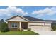 Inviting single-story home showcasing a manicured lawn and a convenient two-car garage at 5829 Valentino Way, Lakeland, FL 33812