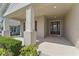 Covered front porch with support columns and a stylish front door, creating a welcoming entrance at 5829 Valentino Way, Lakeland, FL 33812