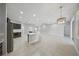 Bright, open kitchen boasts modern appliances and spacious island with beautiful white countertops and herringbone accents at 5829 Valentino Way, Lakeland, FL 33812