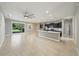 Open-concept kitchen flowing into a large living area, featuring a center island and modern appliances at 5829 Valentino Way, Lakeland, FL 33812