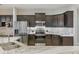 Modern kitchen with stainless steel appliances, dark cabinetry, granite countertops, and stylish backsplash at 5829 Valentino Way, Lakeland, FL 33812