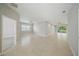 Open-concept living space with tile flooring, multiple ceiling fans, and sliding doors to the outdoors at 5829 Valentino Way, Lakeland, FL 33812