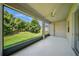 Covered patio with large window, fan, and views of the lush green lawn at 5829 Valentino Way, Lakeland, FL 33812