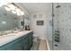 Stylish bathroom with double sinks, custom vanity, modern fixtures, and glass enclosed shower at 605 Ensenada Dr, Orlando, FL 32825