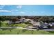 Stunning clubhouse with lush green golf course and manicured landscape under blue skies and scattered clouds at 605 Ensenada Dr, Orlando, FL 32825