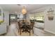 Well-lit dining area features modern light fixture and direct access to a kitchen and screened patio at 605 Ensenada Dr, Orlando, FL 32825