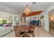 Dining room with round table, wood floors, a hanging pendant light, and adjoins living room at 605 Ensenada Dr, Orlando, FL 32825