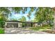 Charming single-story home featuring mature trees, a well-kept lawn, and an attached two-car garage at 605 Ensenada Dr, Orlando, FL 32825
