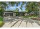 Exterior shot of home with attached garage, landscaped front yard, and long driveway at 605 Ensenada Dr, Orlando, FL 32825
