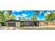 Charming single-story home with a spacious front yard and attached two-car garage at 605 Ensenada Dr, Orlando, FL 32825