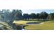 Scenic golf course view featuring lush green fairways, a water hazard, and mature trees at 605 Ensenada Dr, Orlando, FL 32825