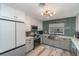 Updated kitchen with white cabinets, stainless steel appliances, and modern countertops at 605 Ensenada Dr, Orlando, FL 32825