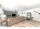 Cozy living room featuring a brick fireplace, ceiling fan, neutral-toned walls, and wood-look flooring at 605 Ensenada Dr, Orlando, FL 32825