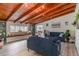 Sunlit living room boasts a wood-beamed ceiling, large windows, and a built-in window seat with storage at 605 Ensenada Dr, Orlando, FL 32825
