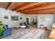 Open living area featuring wood beam ceiling, luxury vinyl plank flooring, and modern furnishings at 605 Ensenada Dr, Orlando, FL 32825
