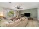 Spacious living room with a decorative fireplace and a large sectional sofa at 605 Ensenada Dr, Orlando, FL 32825