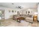 Spacious living room with a large sectional sofa, wood-look floors, and stylish decor at 605 Ensenada Dr, Orlando, FL 32825