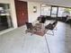 A covered patio with a seating area provides a relaxing outdoor space at 605 Ensenada Dr, Orlando, FL 32825