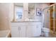 Modern bathroom boasts double sinks, granite counters, tiled shower, and a soaking tub at 7595 Sunny Dreams Ln, Kissimmee, FL 34747